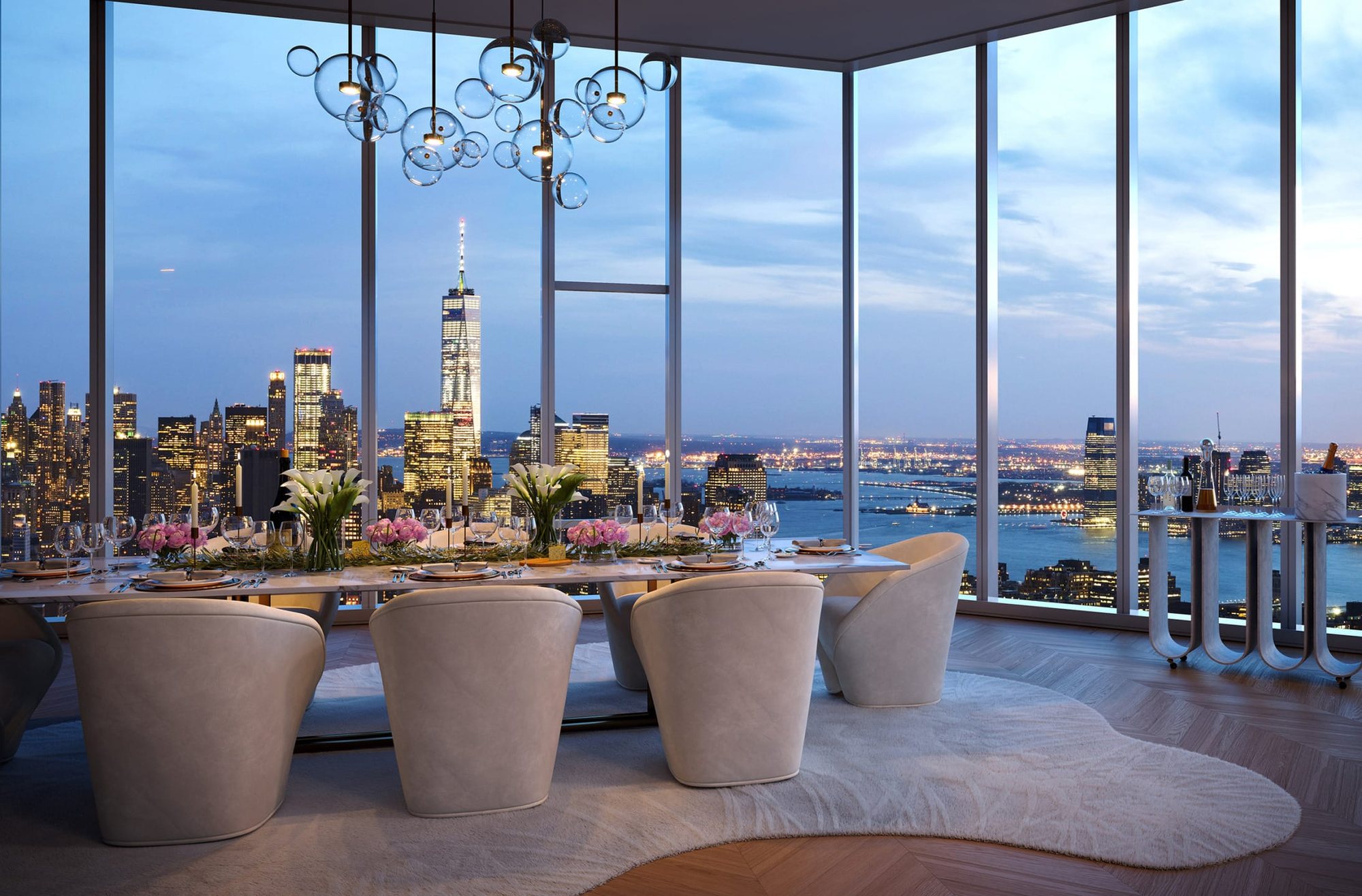 A private penthouse table above the city at dusk
